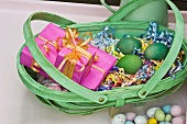Easter nest with wrapped presents in dyed wicker basket