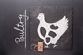 A sketch of a chicken and an English label on a chalkboard
