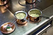Herb sauce in copper pots in a commercial kitchen