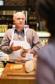 A salesman offering free samples in a supermarket