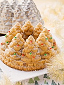 A Christmas tree cake with the baking tin in the background