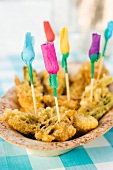 Fried artichokes decorated with paper flowers (Spain)