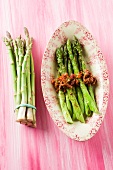 Fried asparagus with dried tomatoes and pepper
