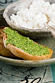 A slice of bread topped with rocket pesto with cottage cheese