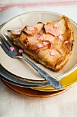 A slice of nectarine and apple tart decorated with sugar hearts