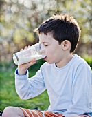 A little boy drinking a glass of milk