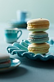 Three Blue and Yellow Macaroons; Stacked on a Blue Plate