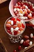 Containers of Pink, Red and White Jelly Beans on a Tray