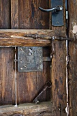 Skeleton key resting on old wooden door