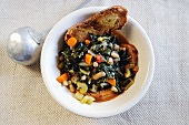 Black cabbage, bean and crostini stew (Tuscany, Italy)
