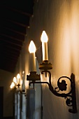 Candle style wall sconce illuminated