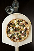 Pizza Topped with Figs, Goat Cheese, Pancetta and Pest; On a Pizza Paddle; From Above