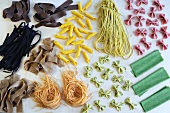 An arrangement of various colourful types of pasta
