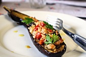 Aubergine filled with rice, tomatoes and pork