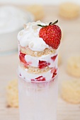 A push-up cake pop with strawberries, quark cream and almonds