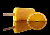An orange lolly and a slice of orange