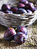 Plums, some in a basket