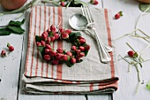 Small wreath of hypericum berries on linen napkin