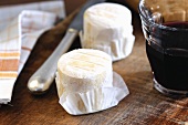 Goat's cheese on a wooden board with a glass of wine