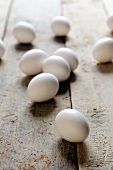 White eggs on a wooden surface