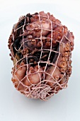 A cooked octopus in a net (for carpaccio)