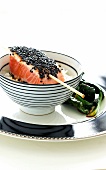 Salmon fillet with black sesame seeds on a bed of rice (Asia)