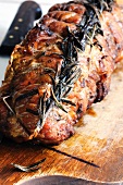 Veal roulade with rosemary on a chopping board
