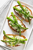 Bruschetta topped with asparagus and rocket