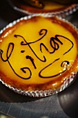 A lemon tart with writing