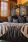 Brown African printed bedding on bed