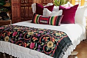 Colorful bed runner and pillows on bed