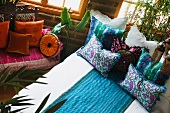 Colorful bed runner and pillows on bed