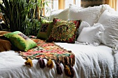 Colorful bed runner and throw pillows on bed
