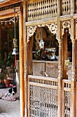 Old, Oriental, carved wooden panel enclosing veranda