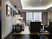 Elegant interior with classic, upholstered suite and modern, indirect lighting