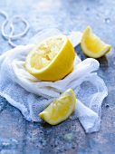 Two Squeezed Lemon Slices with Half a Squeezed Lemon; Cheese Cloth