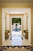 Interior of a marble hallway leading to a pool