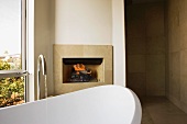 Stand Alone Bathtub in Front of Fireplace