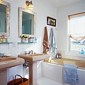 Sunny bathroom with two pedestal washstands