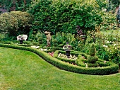 Well-tended gardens with statue and topiary