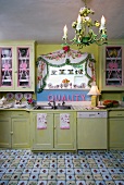 Dramatic, vintage kitchen with pink accessories and lino flooring designed to look like tiles