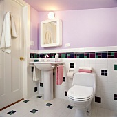 Sink and toilet in bathroom with lavender wall