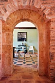 Red brick doorway between kitchen and dining room