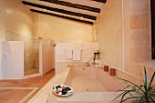 Large bathroom with ceiling beams and tile floor