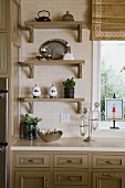 Shelves in kitchen against tile wall