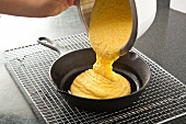 Pouring Corn Bread Batter into a Cast Iron Skillet