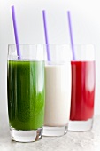 Three Assorted Smoothies in Glasses with Straws