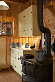 Old stove in kitchen of rustic wooden cabin