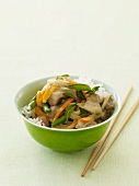 Chicken Stir Fry Over Rice in a Green Bowl; Chopsticks