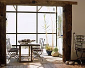 Dining table in rustic extension with glazed facade